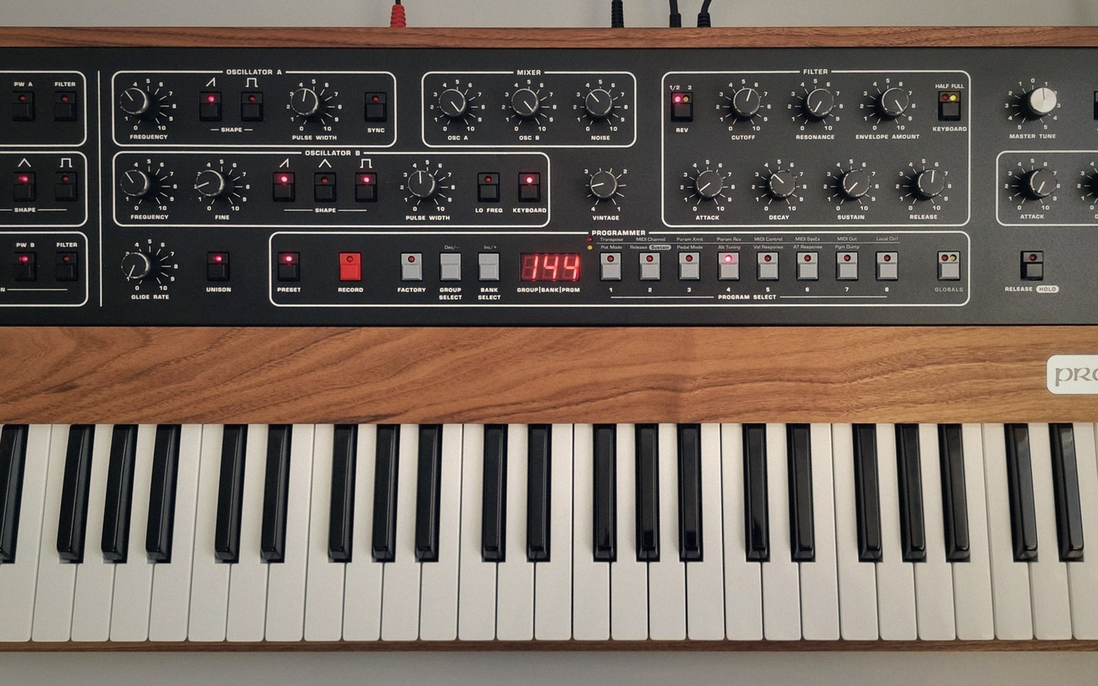 Control panel and keyboard of a Prophet synthesizer with oscillator, filter and mixer knobs