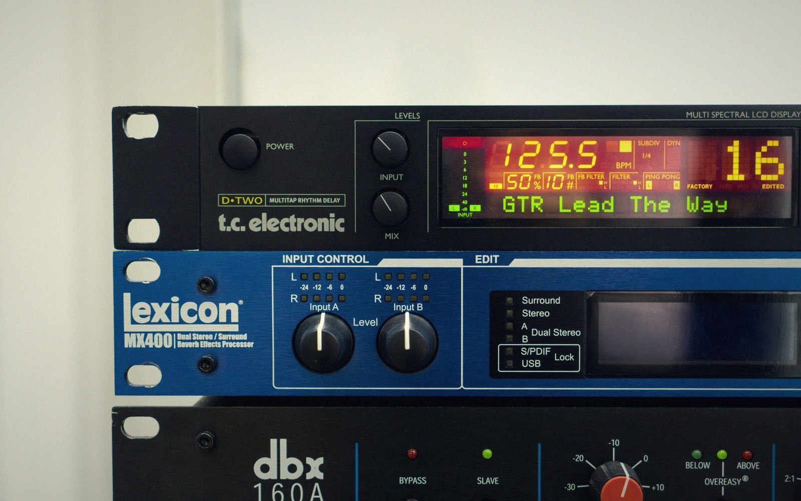 Rack-mounted studio gear including a TC Electronic delay, Lexicon MX400, and dbx 160A compressor